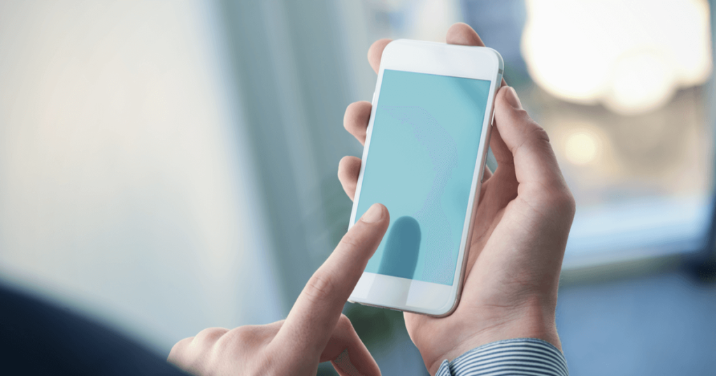 スマホをタッチしようとしている指